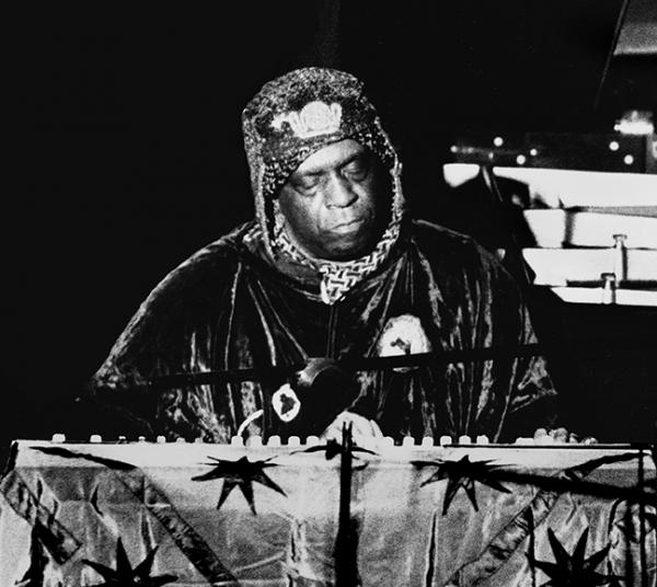Man in costume on stage.